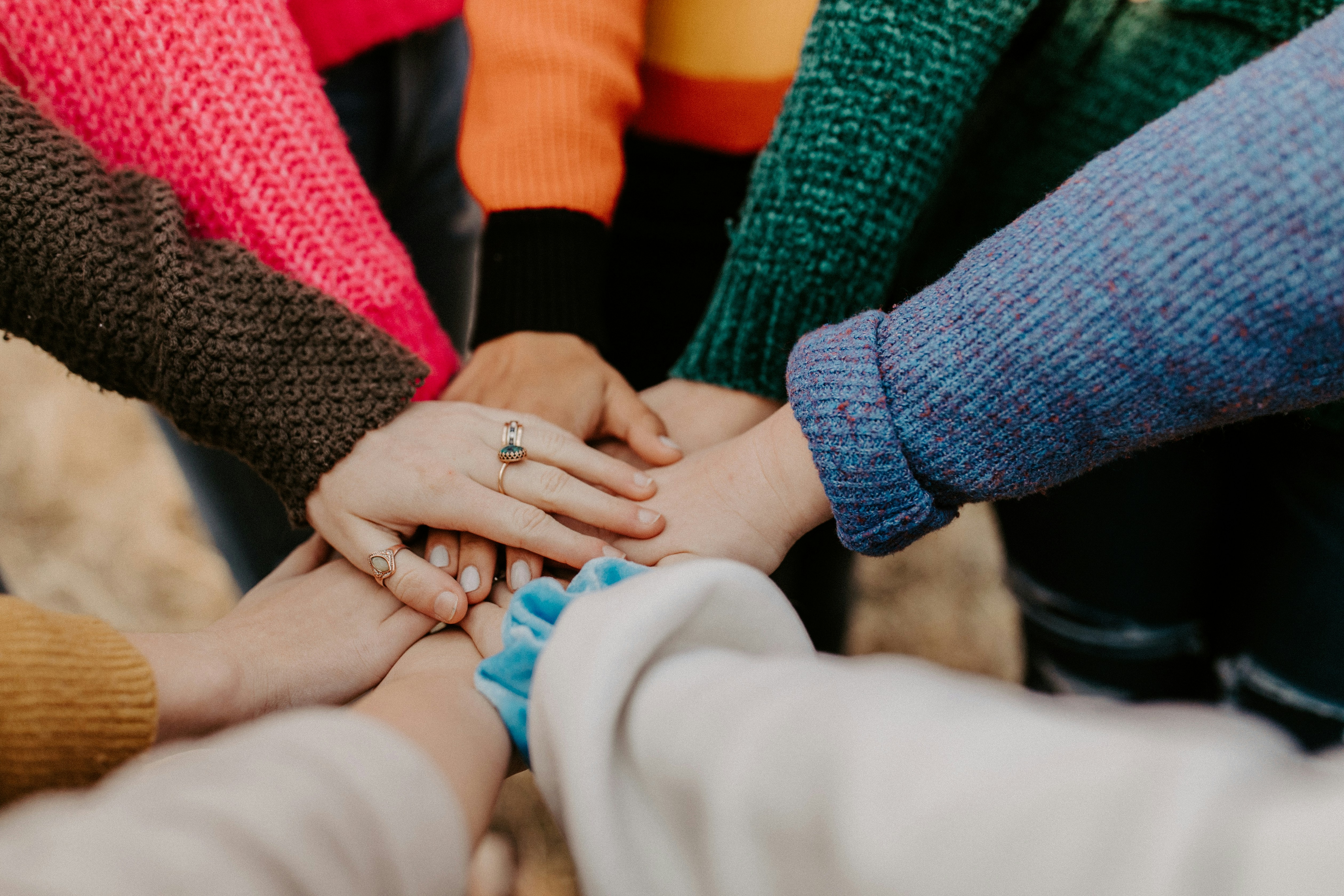 A group of people joining hands together